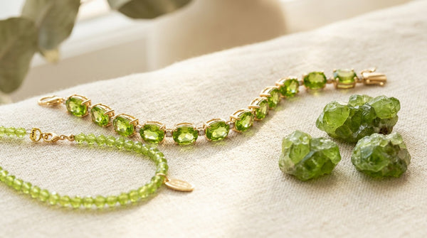 Peridot gemstone bracelet and raw peridot crystals in warm sunlight